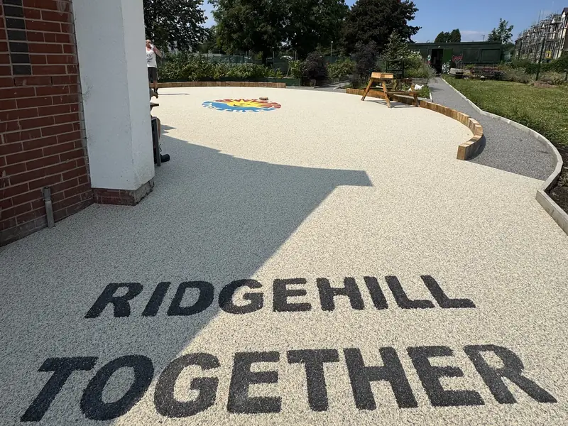 Ridgehill Together resin bound courtyard with black resin lettering and a colour logo inlay
